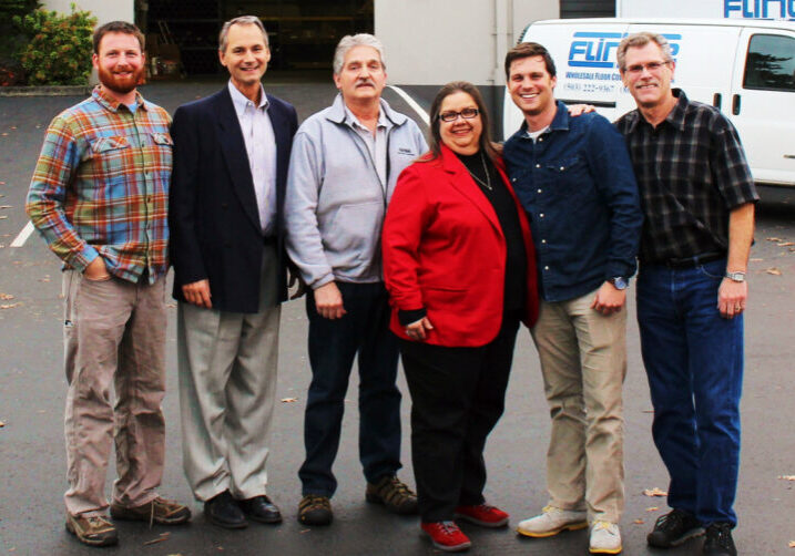 The Flintile Inc staff in a group photo in front of the office